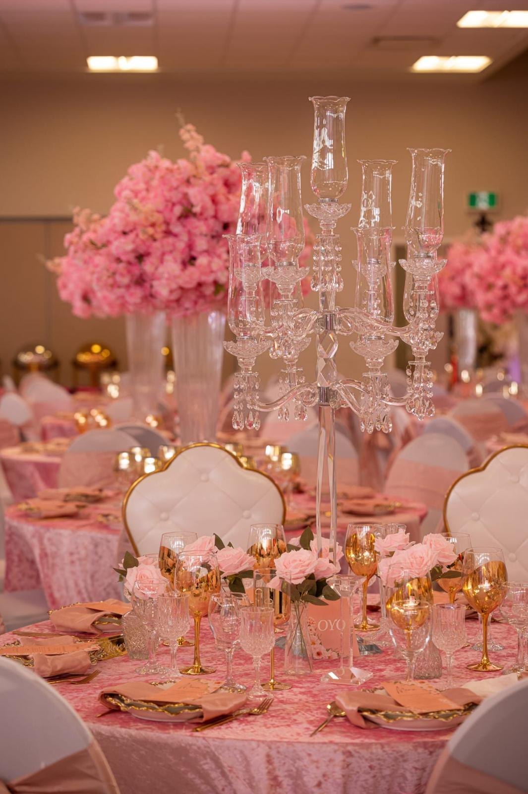 Crystal and blossom centrepiece on a dressed table